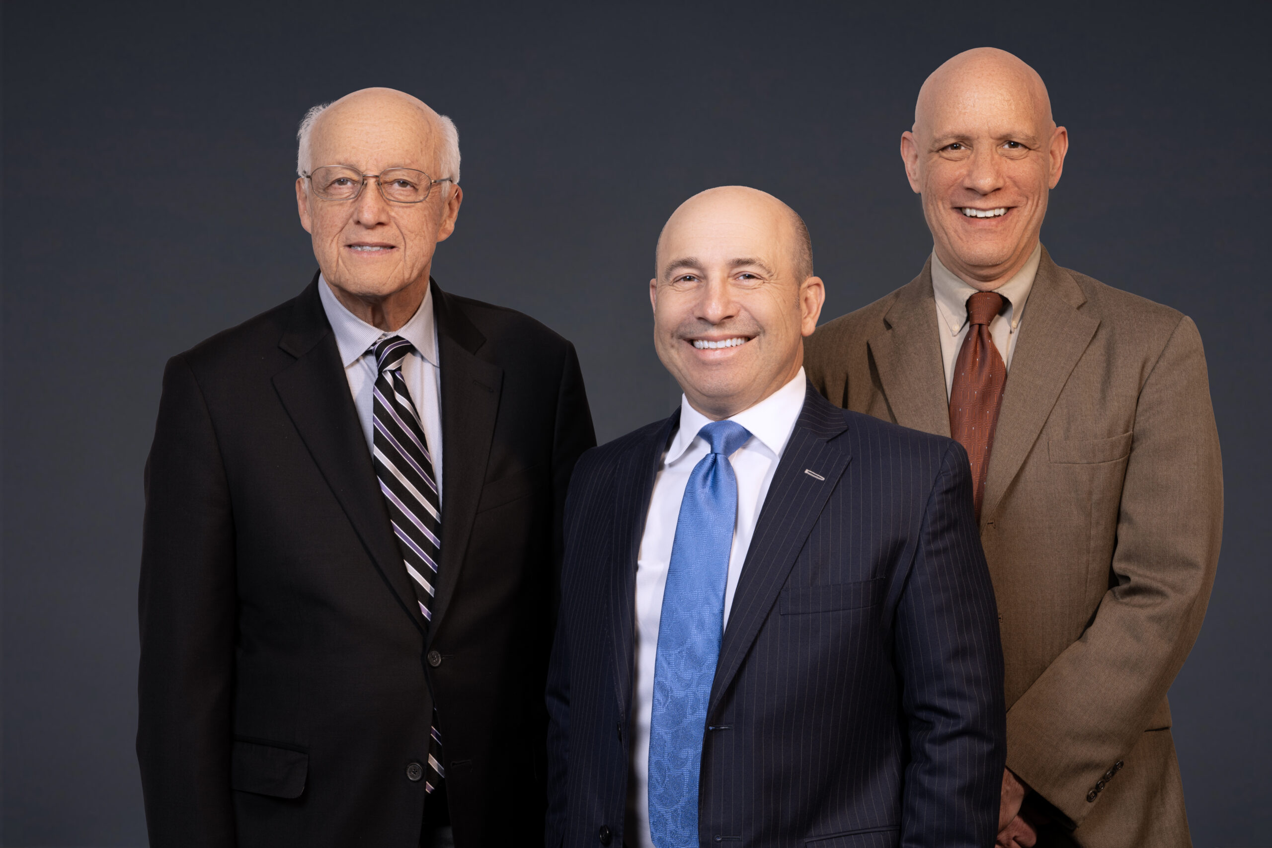 Three attorneys smiling