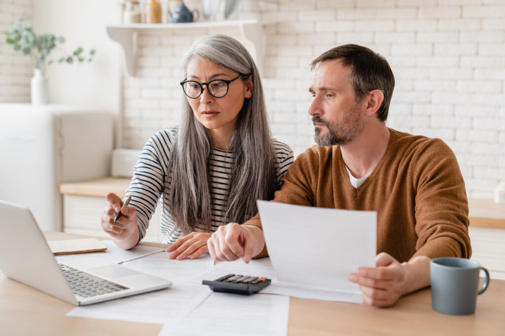 Middle aged couple working on documents