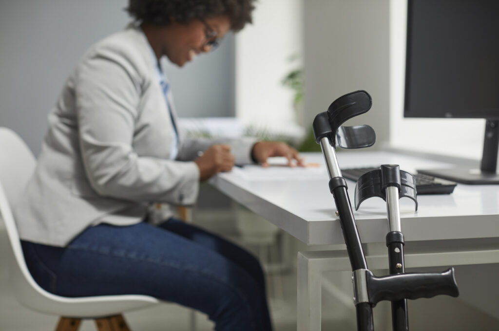 Disabled employee working in office.